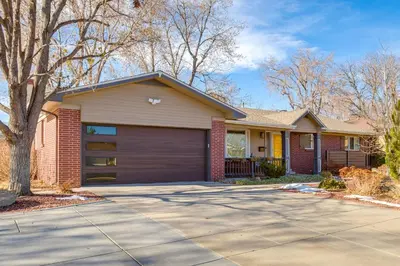 a house with a garage and a driveway at 9 Mi to Red Rocks Modern Getaway with Private Yard in Lakewood