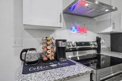 a kitchen with a coffee maker on a counter at Modern 2BR 2BA Townhome 15 Min to DEN in Commerce City