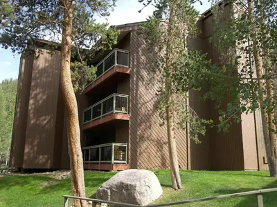 a building with trees in front of it at Wild Irishman 2 bed 1 and half bath WIGK in Keystone