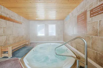 a bathroom with a hot tub with a wooden ceiling at Wild Irishman 2 bed 1 and half bath WIGK in Keystone