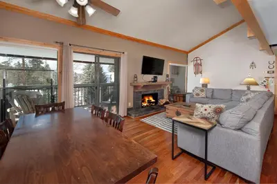 a living room with a table and a fireplace at Wild Irishman 2 bed 1 and half bath WIGK in Keystone