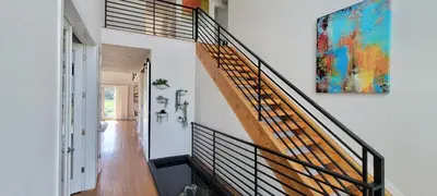 a staircase in a house with a painting on the wall at Perfectly Between Boulder- Estes in Longmont