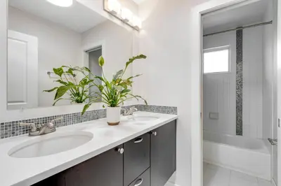 a white bathroom with a sink and a mirror at Perfectly Between Boulder- Estes in Longmont