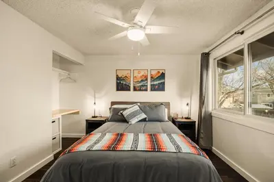 a bedroom with a bed and a ceiling fan at The Loveland Haus in Loveland