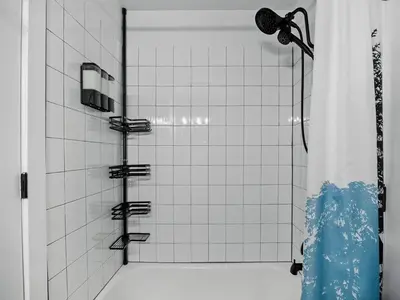 a shower with a shower head in a bathroom at The Loveland Haus in Loveland