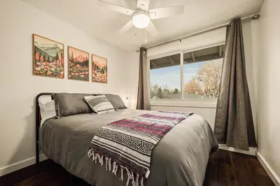 a bedroom with a bed and a window at The Loveland Haus in Loveland
