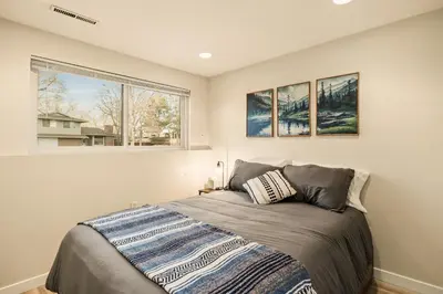 a bedroom with a bed and a window in it at The Loveland Haus in Loveland