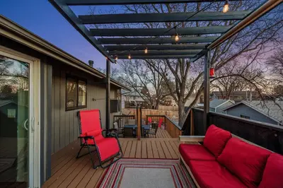 a patio with a couch and chairs on a deck at The Loveland Haus in Loveland