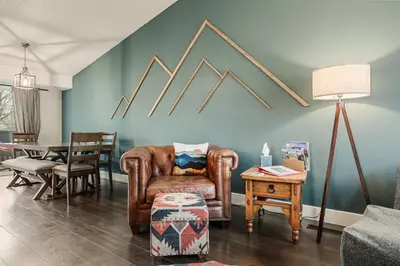 a living room with a chair and a table at The Loveland Haus in Loveland