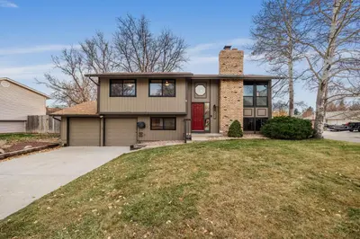 a house with a brick chimney on top of a yard at The Loveland Haus in Loveland