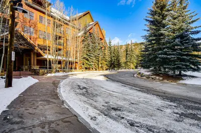 an empty road in front of a building with a tree at Walk to Gondola! Keystone Gem in River Run Village in Keystone