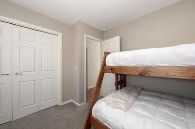 a bedroom with two bunk beds and a closet at Comfortable Mountain Getaway near Winter Park in Fraser
