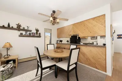 a dining room and kitchen with a table and chairs at Comfortable Mountain Getaway near Winter Park in Fraser