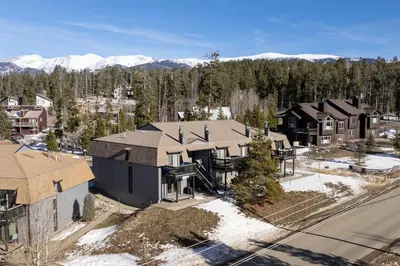 an aerial view of a house with mountains in the background at Comfortable Mountain Getaway near Winter Park in Fraser