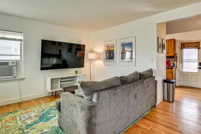 a living room with a couch and a flat screen tv at 7 Mi to Dtwn Denver Pet-Friendly Home with Yard in Aurora
