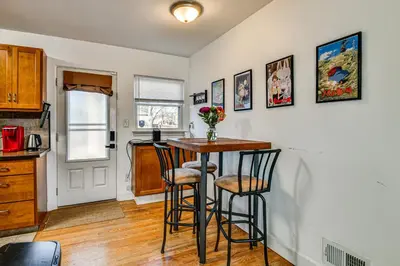 a kitchen with a table and two stools at 7 Mi to Dtwn Denver Pet-Friendly Home with Yard in Aurora