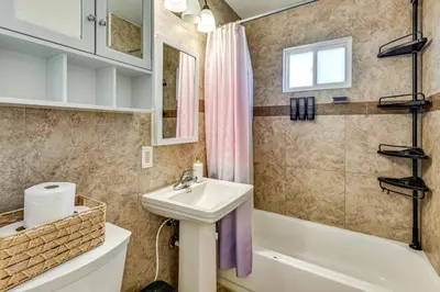 a bathroom with a sink and a toilet and a tub at 7 Mi to Dtwn Denver Pet-Friendly Home with Yard in Aurora