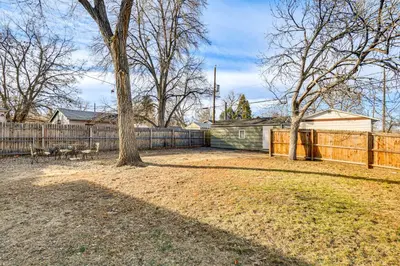 a yard with a fence and a tree at 7 Mi to Dtwn Denver Pet-Friendly Home with Yard in Aurora