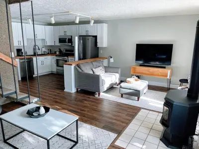 a living room with a couch a table and a kitchen at Spacious Dillon Basecamp, close to resorts! in Dillon