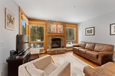 a living room with a couch and a fireplace at Settlers Creek 6526 in Keystone
