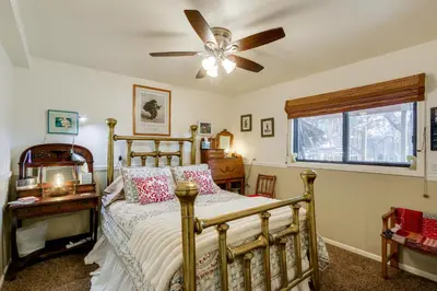 a bedroom with a bed and a ceiling fan at 6 Mi to Dtwn Fort Collins Cozy Apt with Shared Yard in Fort Collins