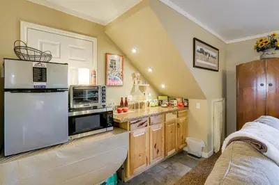 a kitchen with wooden cabinets and stainless steel appliances at 6 Mi to Dtwn Fort Collins Cozy Apt with Shared Yard in Fort Collins