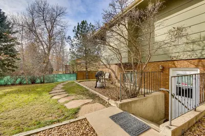 a house with a fire hydrant next to a fence at 6 Mi to Dtwn Fort Collins Cozy Apt with Shared Yard in Fort Collins