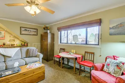 a living room with a couch and a table at 6 Mi to Dtwn Fort Collins Cozy Apt with Shared Yard in Fort Collins