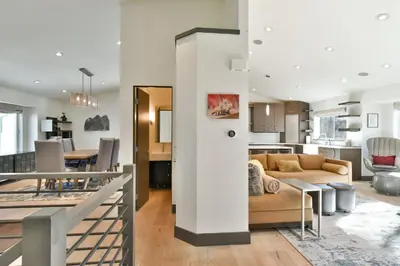 a living room and kitchen with a couch and a table at You Are My Sunshine - Downtown Frisco Home in Frisco