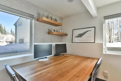 a room with a wooden desk with two monitors on it at You Are My Sunshine - Downtown Frisco Home in Frisco