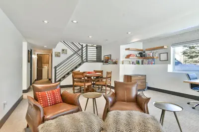 a living room with leather chairs and a table at You Are My Sunshine - Downtown Frisco Home in Frisco