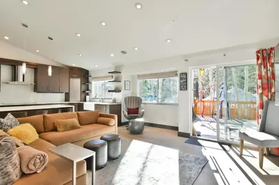 a living room with a couch and a kitchen at You Are My Sunshine - Downtown Frisco Home in Frisco