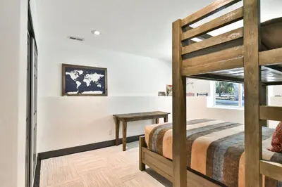 a bedroom with a bunk bed and a desk at You Are My Sunshine - Downtown Frisco Home in Frisco