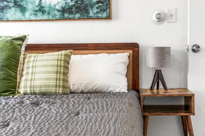 a bedroom with a bed and a nightstand with a lamp at Prime Location - Walking Distance to Old Town Arvada - 2 bedrooms 3 beds 1 bath in Arvada