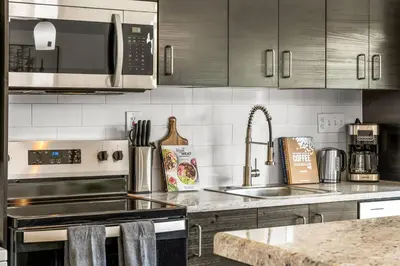 a kitchen with a sink and a stove top oven at Prime Location - Walking Distance to Old Town Arvada - 2 bedrooms 3 beds 1 bath in Arvada