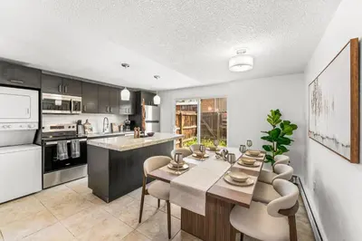 a kitchen with a table and chairs in a kitchen at Prime Location - Walking Distance to Old Town Arvada - 2 bedrooms 3 beds 1 bath in Arvada
