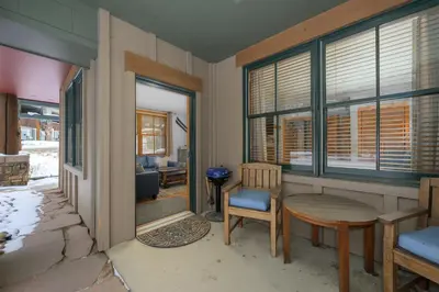 a living room with a table and chairs and windows at Premium Unit 1100 - One Bedroom - Zephyr Mountain Lodge condo in Winter Park