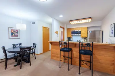 a kitchen and dining room with a table and chairs at 503 Ski Run condo in Keystone