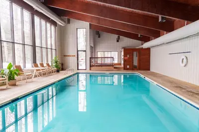 a swimming pool with blue water in a building at 503 Ski Run condo in Keystone