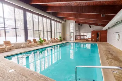 a large pool in a hotel with chairs and tables at 503 Ski Run condo in Keystone