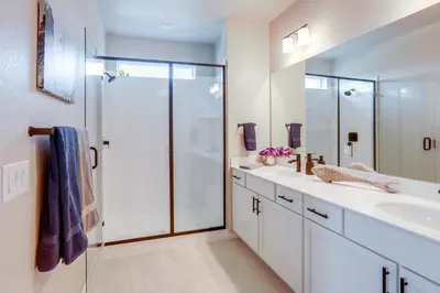 a bathroom with a glass shower and a sink at Creekside Retreat Near Olde Town Arvada in Arvada