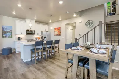 a kitchen and dining room with a table and chairs at Creekside Retreat Near Olde Town Arvada in Arvada