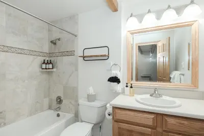 a bathroom with a sink toilet and a mirror at Cozy Winter Park Ski & Bike Retreat in Winter Park