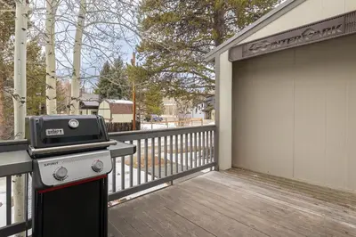 a grill on a deck next to a garage at Cozy Winter Park Ski & Bike Retreat in Winter Park