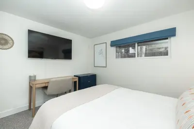 a bedroom with a bed and a desk and a window at Cozy Winter Park Ski & Bike Retreat in Winter Park
