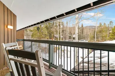 a balcony with a chair and a view of the mountains at Wild Irishman 1029 - Keystone in Dillon