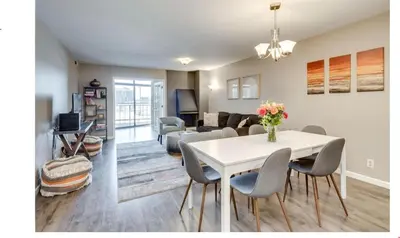 a living room with a white table and chairs at 2BR Condo in Heart of LoDo with Great Amenities in Denver