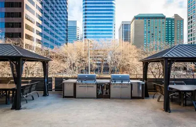 a patio with tables and chairs and buildings at 2BR Condo in Heart of LoDo with Great Amenities in Denver