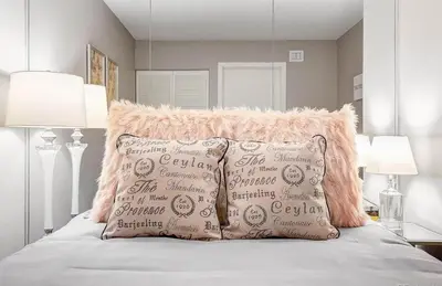 a bedroom with a bed with two pillows on it at 2BR Condo in Heart of LoDo with Great Amenities in Denver