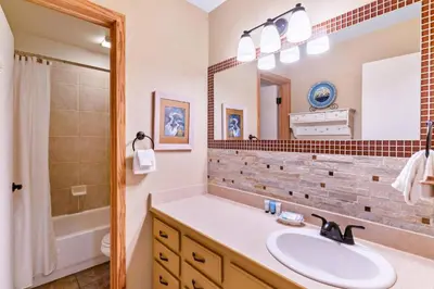 a bathroom with a sink and a shower and a mirror at Lakepoint 807C - Frisco in Frisco